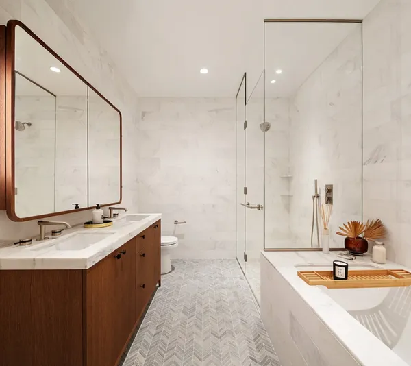 a bathroom with a tub sink and mirror