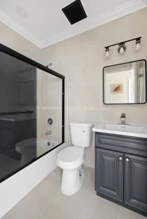 a bathroom with a toilet sink and mirror