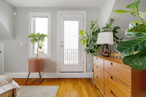 a view of living room with furniture and a potted plant