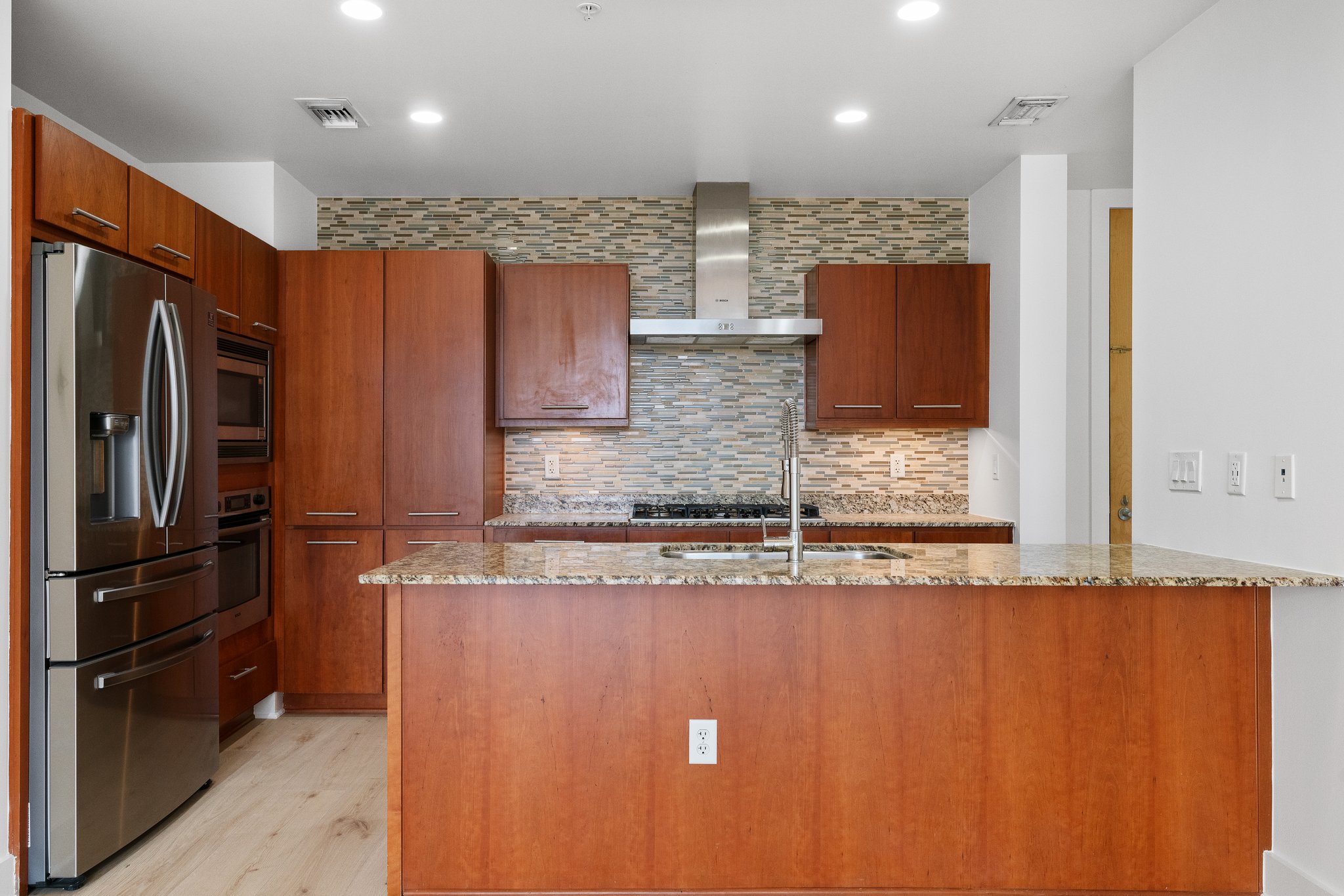210 Lee Barton Drive, Unit 517 Austin, TX 78704 - Photo 11 of 32 a kitchen with stainless steel appliances granite countertop a refrigerator and a sink