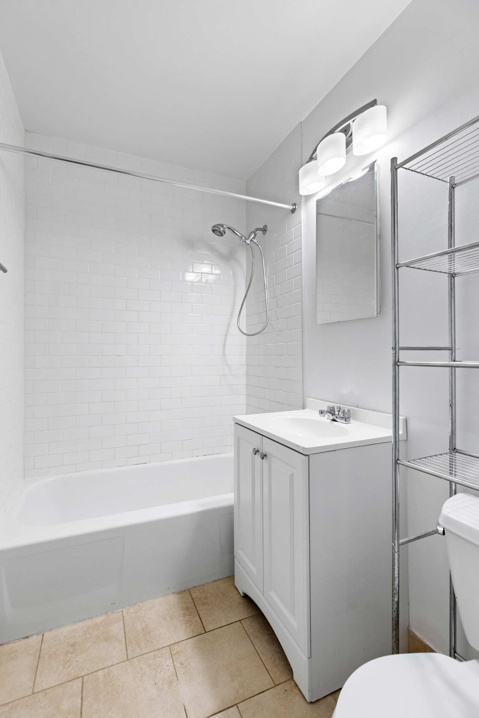 136 East 30th Street, Unit 3R Manhattan, NY 10016 - Photo 12 of 23 a bathroom with a granite countertop sink mirror toilet and bathtub