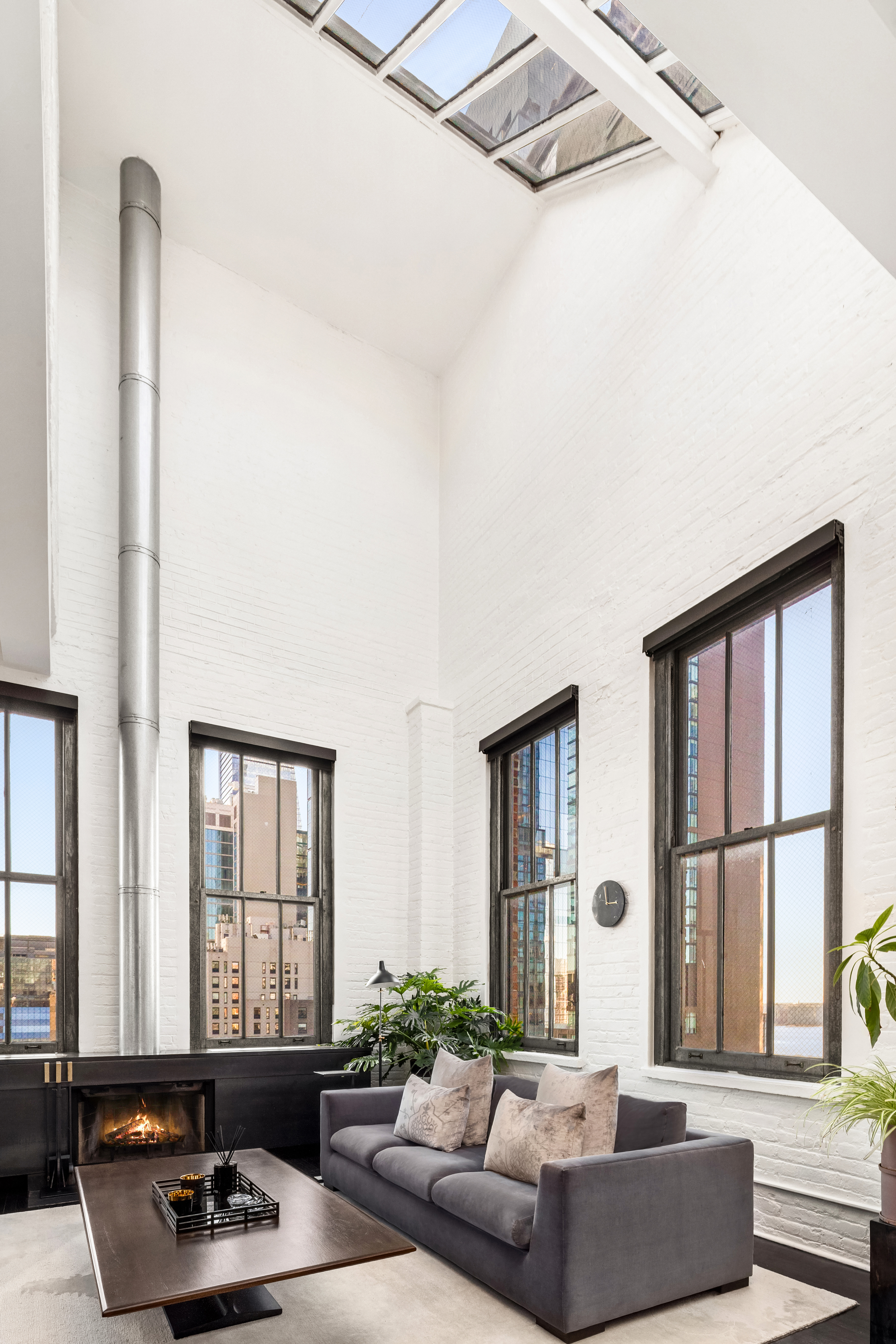 448 West 37th Street, Unit 11G/12G Manhattan, NY 10018 - Photo 5 of 17 a living room with furniture and a large window