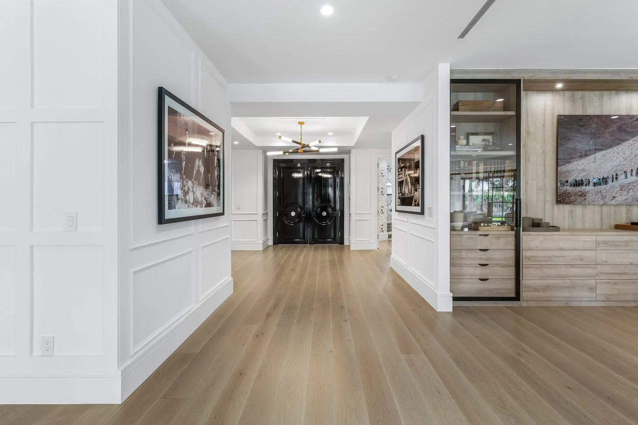 wooden floor with view of an empty room