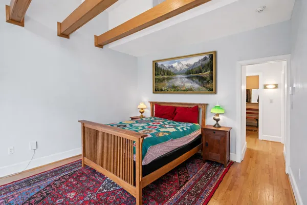 a bed room with a bed and paintings on the wall
