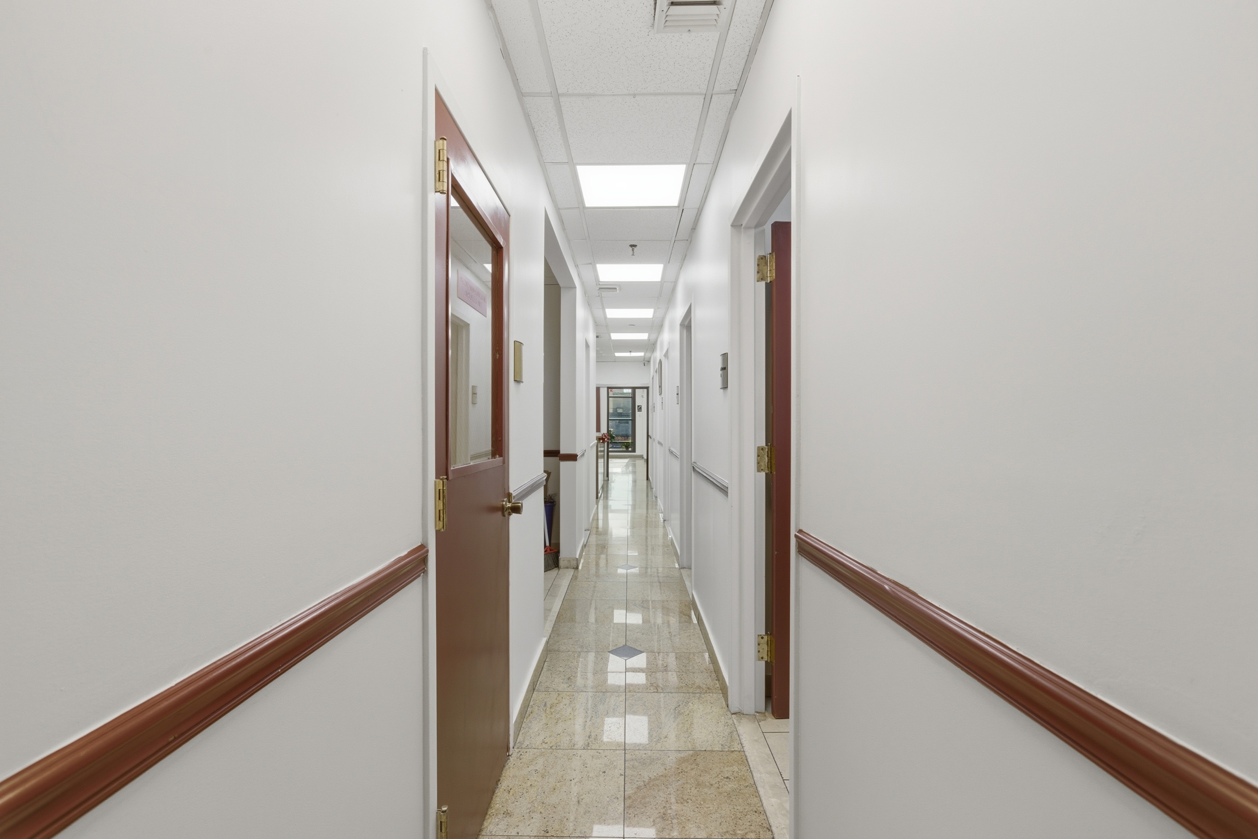 5203-5207 Church Avenue Brooklyn, NY 11203 - Photo 8 of 14 a view of a hallway with wooden floor and staircase