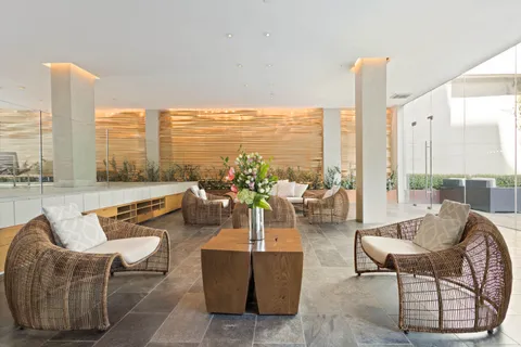 a living room with furniture and floor to ceiling windows