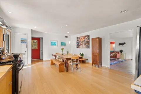 a living room with furniture a dining table and a flat screen tv