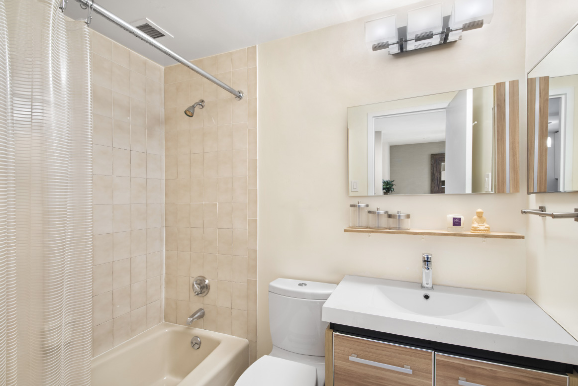 445 West 19th Street, Unit 6C Manhattan, NY 10011 - Photo 6 of 10 a bathroom with a sink a toilet and shower