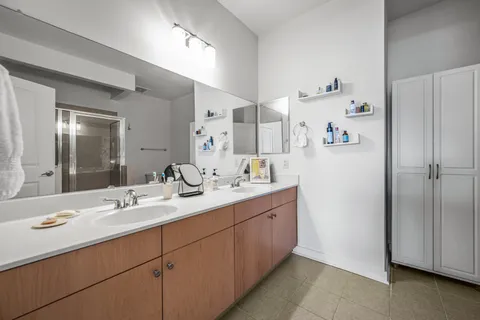 a bathroom with a double vanity sink mirror and double