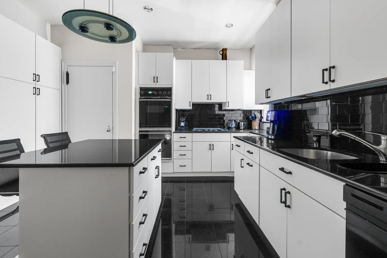 a kitchen with stainless steel appliances a sink a stove a microwave and cabinets