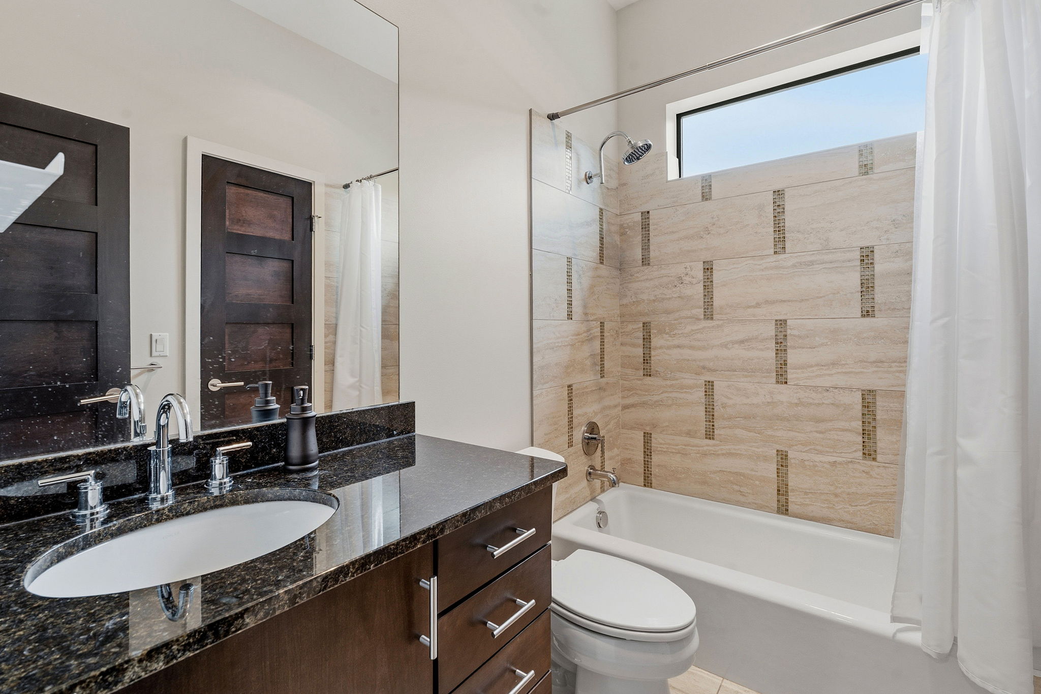 3605 Robbins Road Austin, TX 78730 - Photo 29 of 51 a bathroom with a sink a toilet a mirror a bathtub and shower