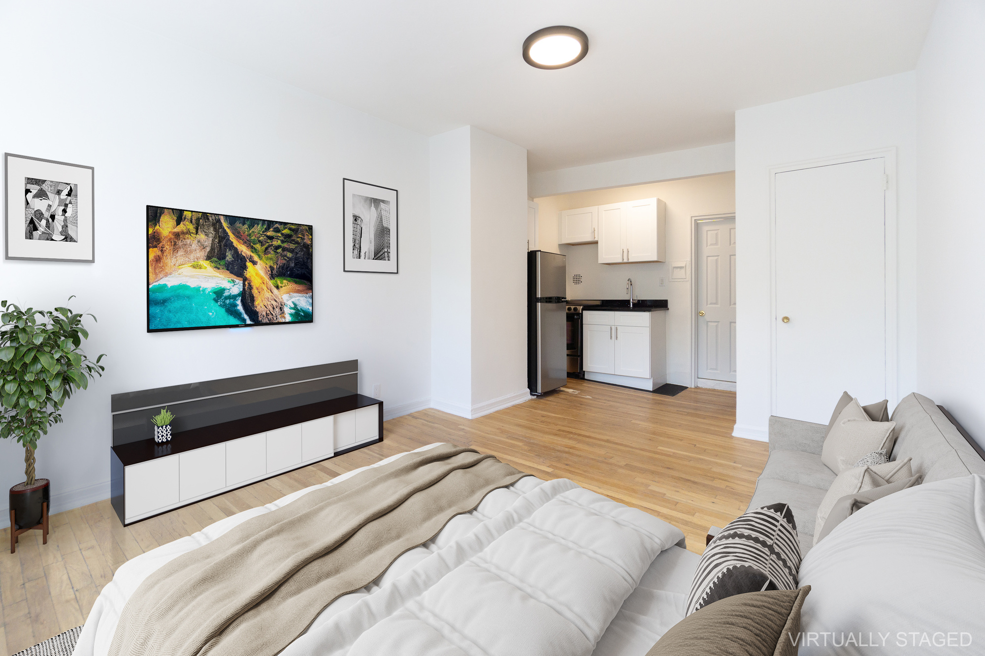 319 East 5th Street, Unit 9 Manhattan, NY 10003 - Photo 3 of 12 a bedroom with a bed and a potted plant