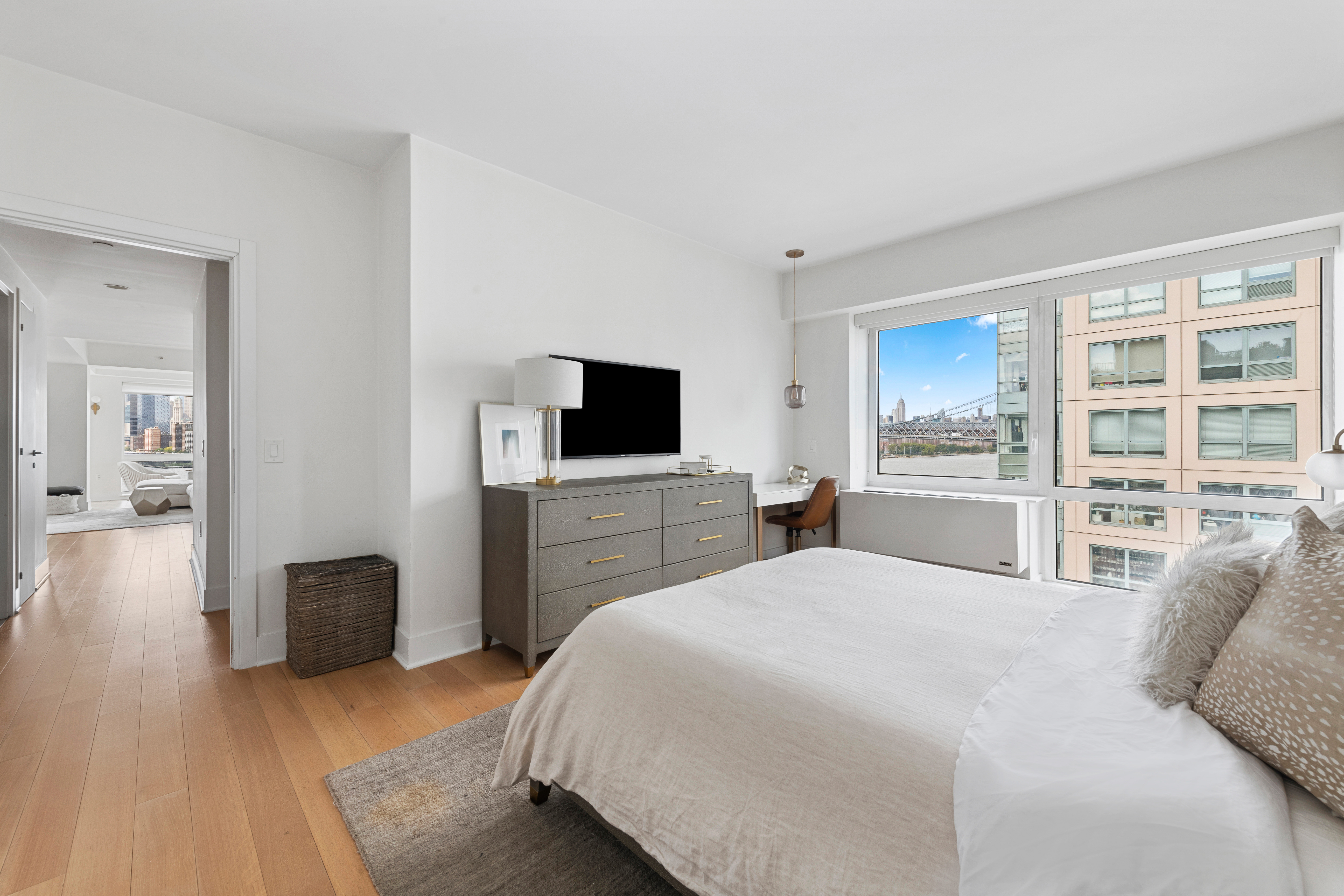 446 Kent Avenue, Unit 14A Brooklyn, NY 11249 - Photo 11 of 19 a bedroom with a bed and a flat screen tv