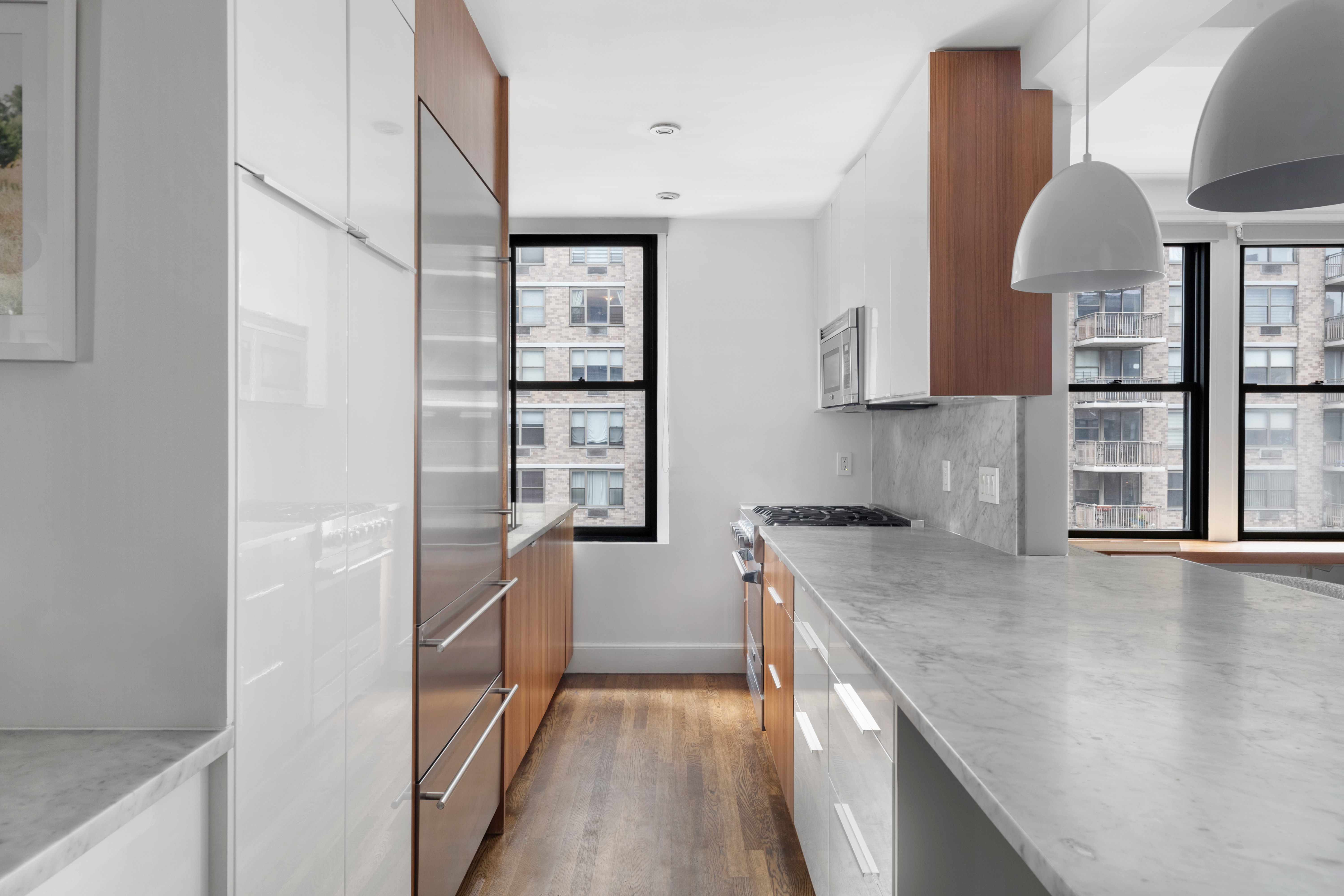 308 East 79th Street, Unit 13EF Manhattan, NY 10075 - Photo 4 of 16 a kitchen with a sink a stove and cabinets
