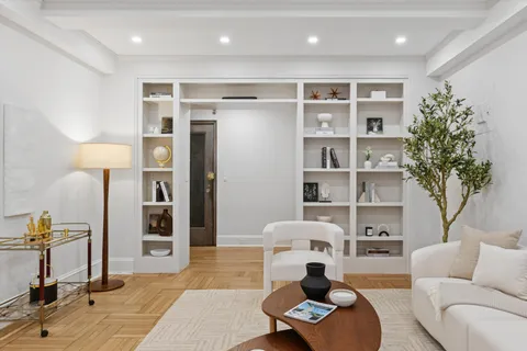 a living room with furniture and a potted plant