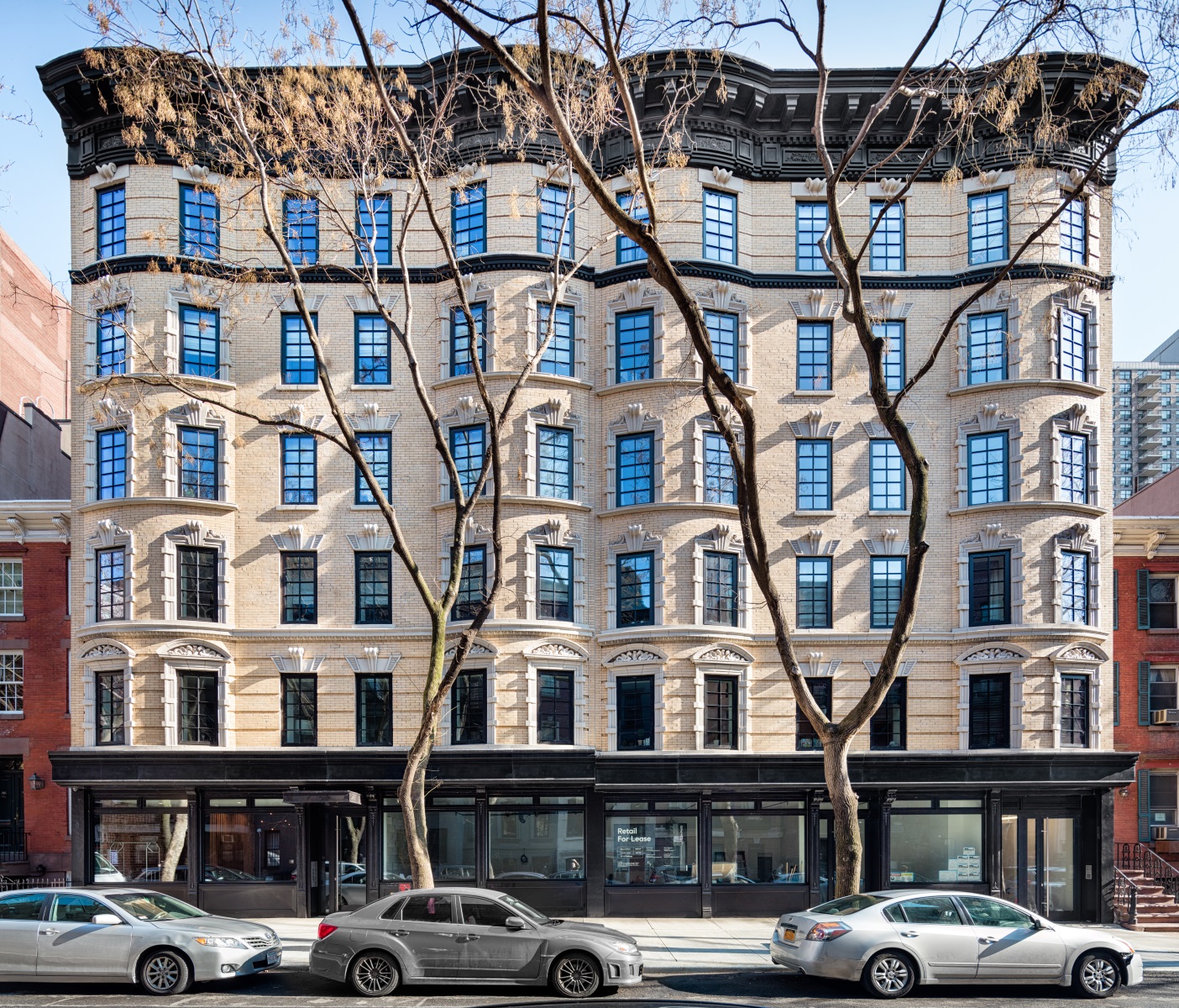 245 East 78th Street, Unit 5A Manhattan, NY 10075 - Photo 11 of 14 a front view of a building with lot of cars and trees