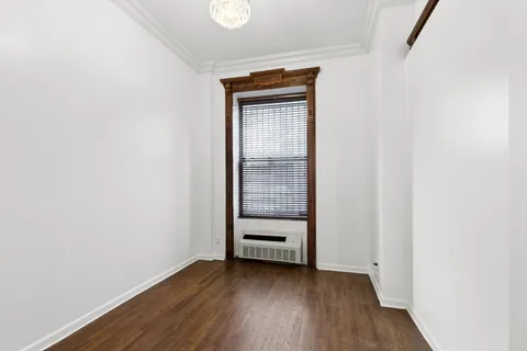 a view of a room with wooden floor and closet