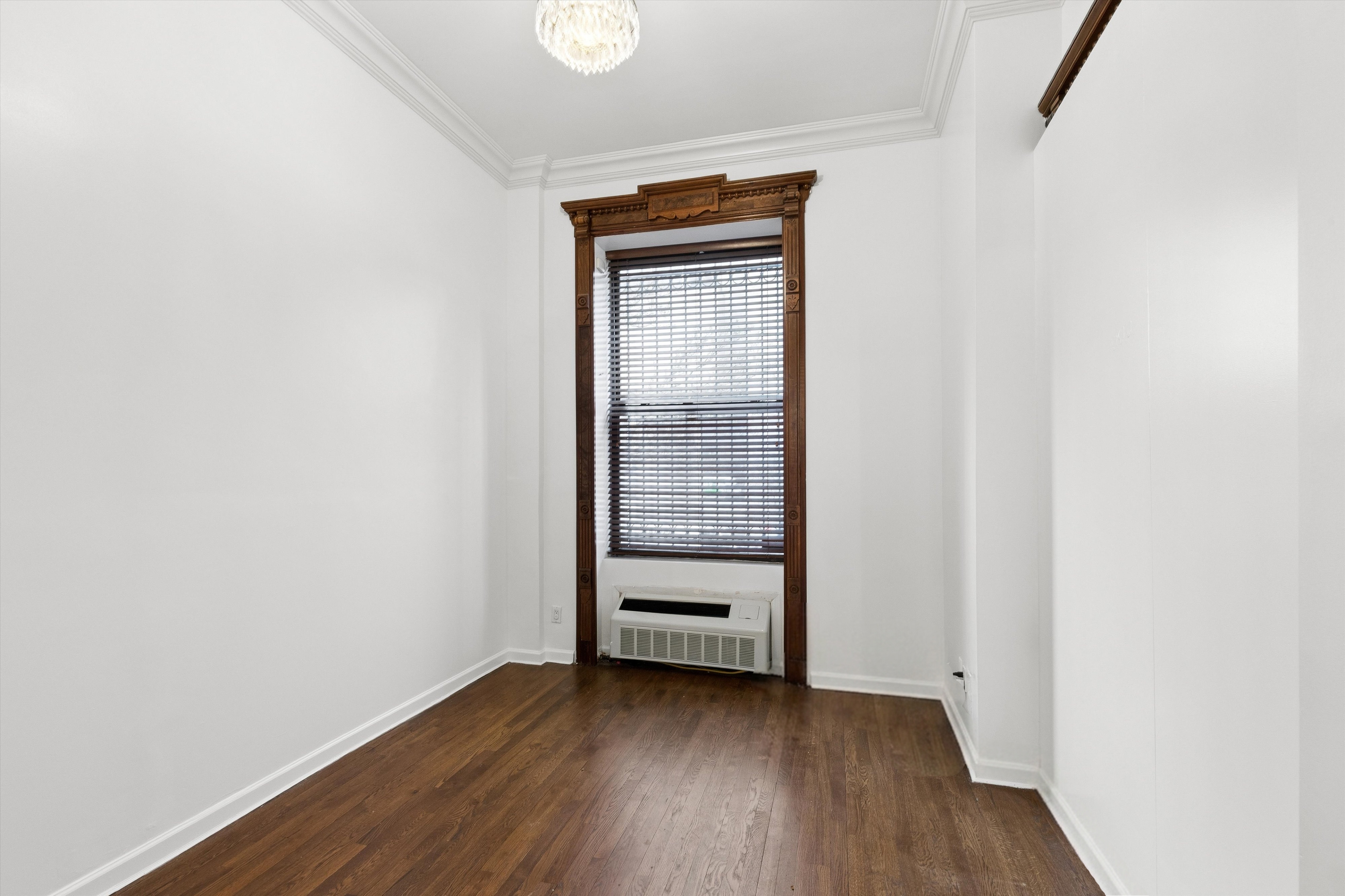165 West 126th Street Manhattan, NY 10027 - Photo 19 of 40 a view of a room with wooden floor and closet