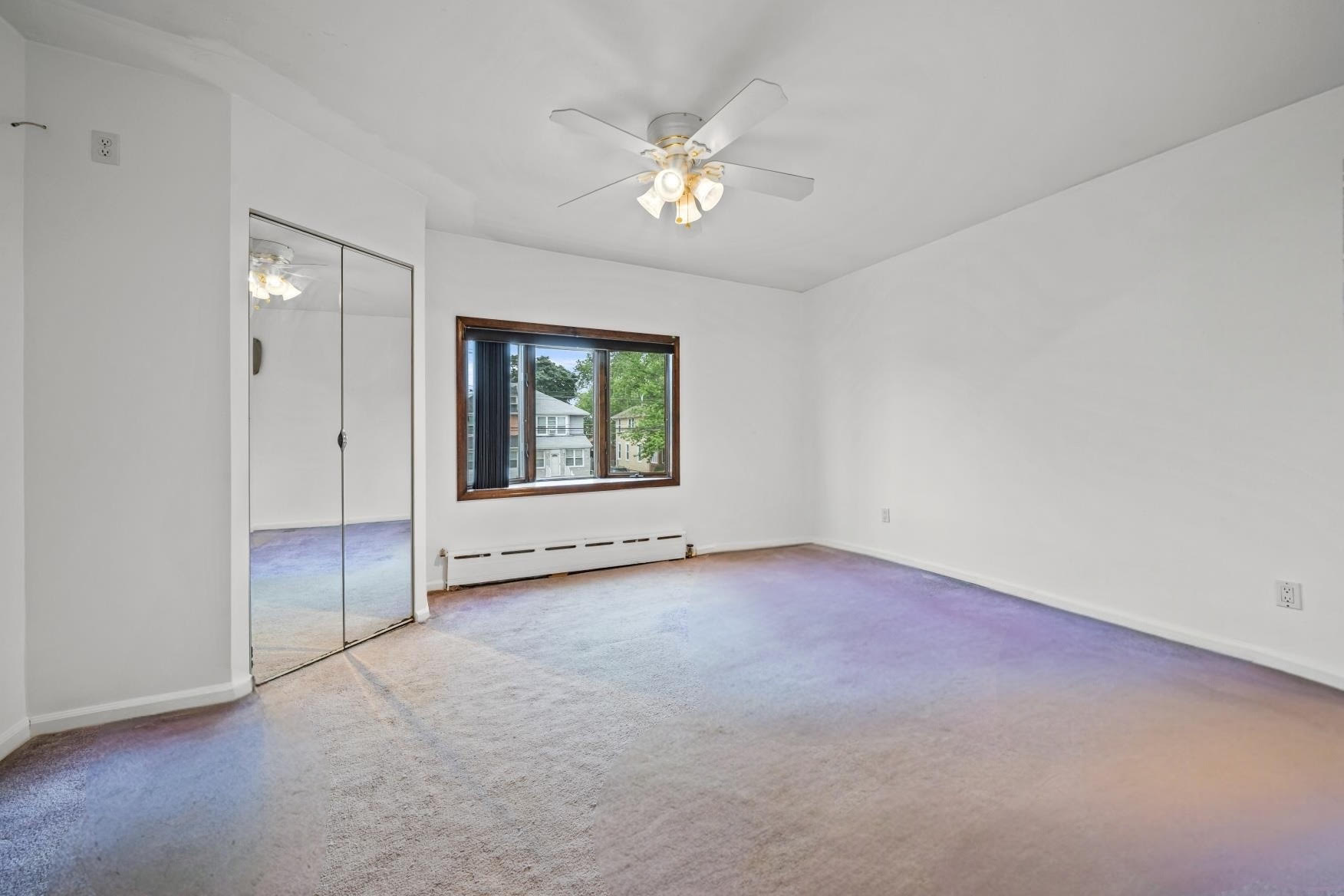2018 Mill Avenue Brooklyn, NY 11234 - Photo 15 of 20 an empty room with chandelier fan and windows