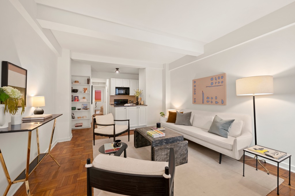 251 West 74th Street, Unit 3B Manhattan, NY 10023 - Photo 3 of 7 a living room with furniture and a lamp