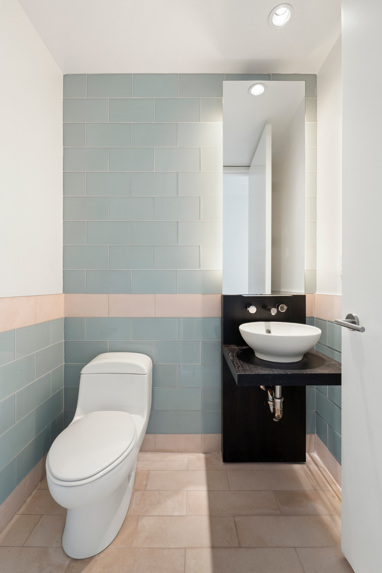 450 East 83rd Street, Unit 23B Manhattan, NY 10028 - Photo 12 of 18 a bathroom with a sink toilet and mirror