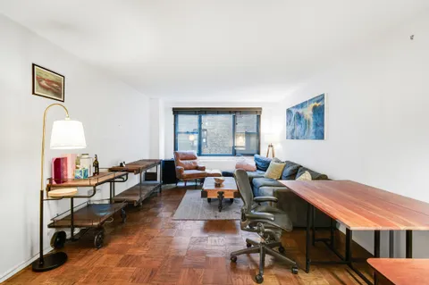 a room with furniture pool table and windows