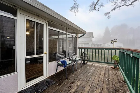 a view of a patio with a table chairs and a backyard