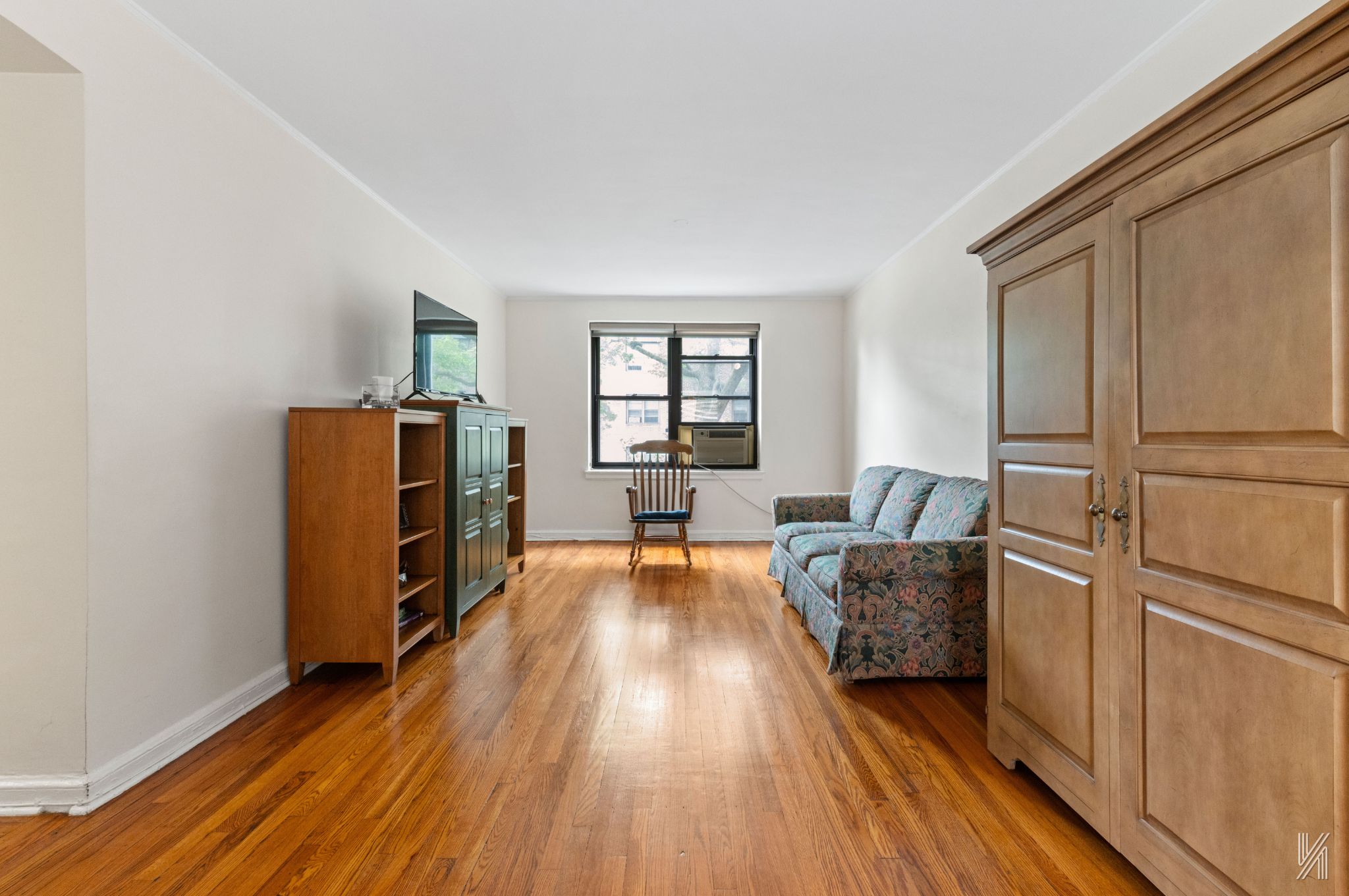 22-08 76th Street, Unit D2 Queens, NY 11370 - Photo 3 of 20 a living room with furniture and a wooden floor