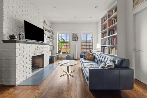 a living room with furniture fireplace and flat screen tv