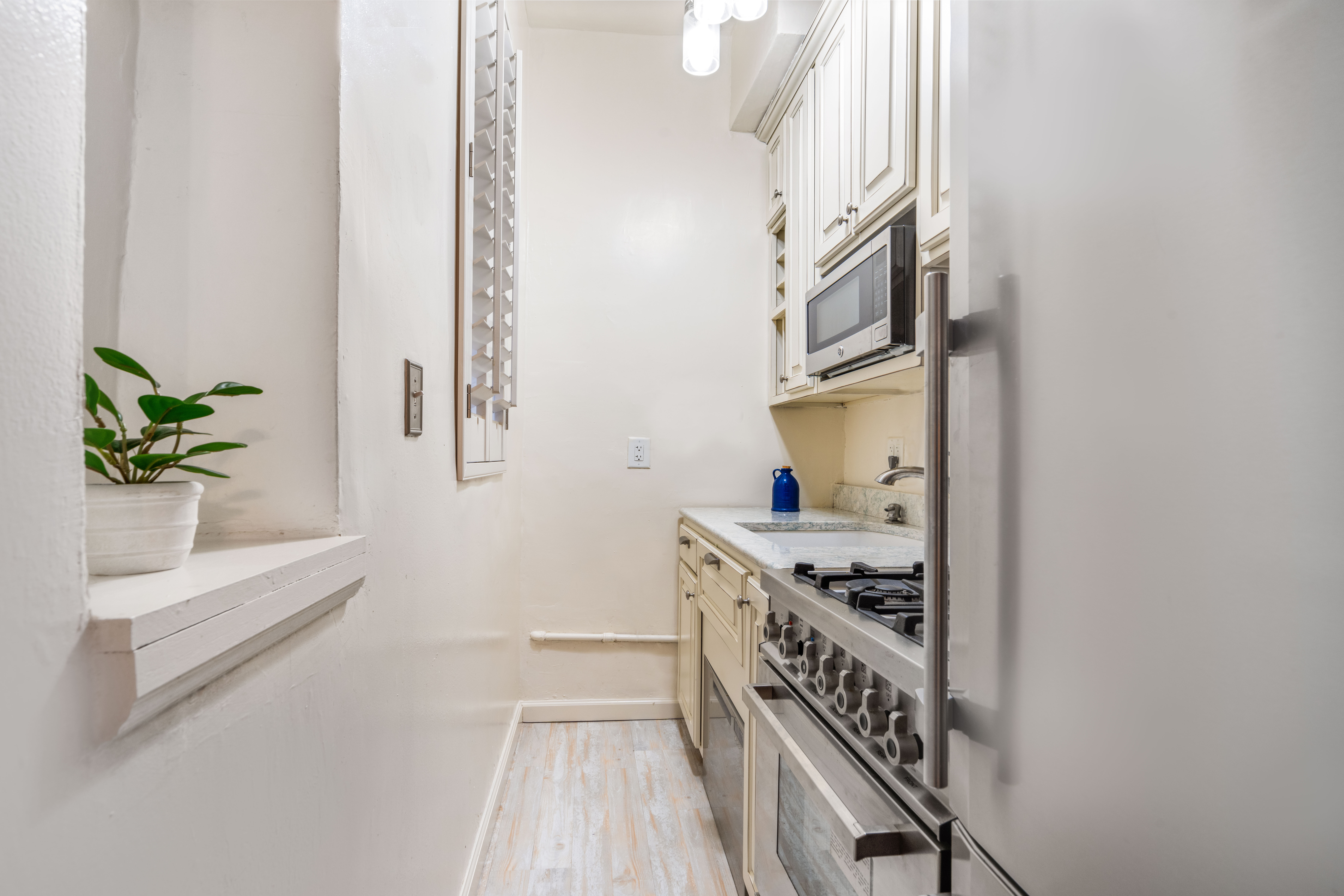 102 West 80th Street, Unit 55 Manhattan, NY 10024 - Photo 4 of 6 a kitchen with stainless steel appliances granite countertop a stove a sink and a refrigerator