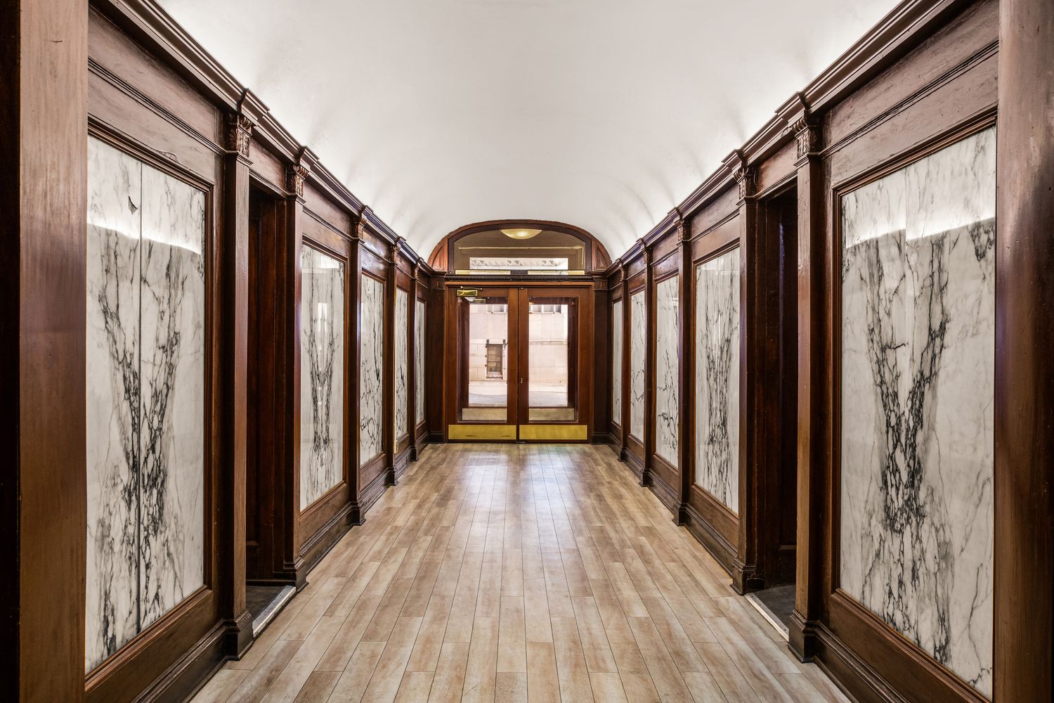a view of a entryway with wooden floor and door