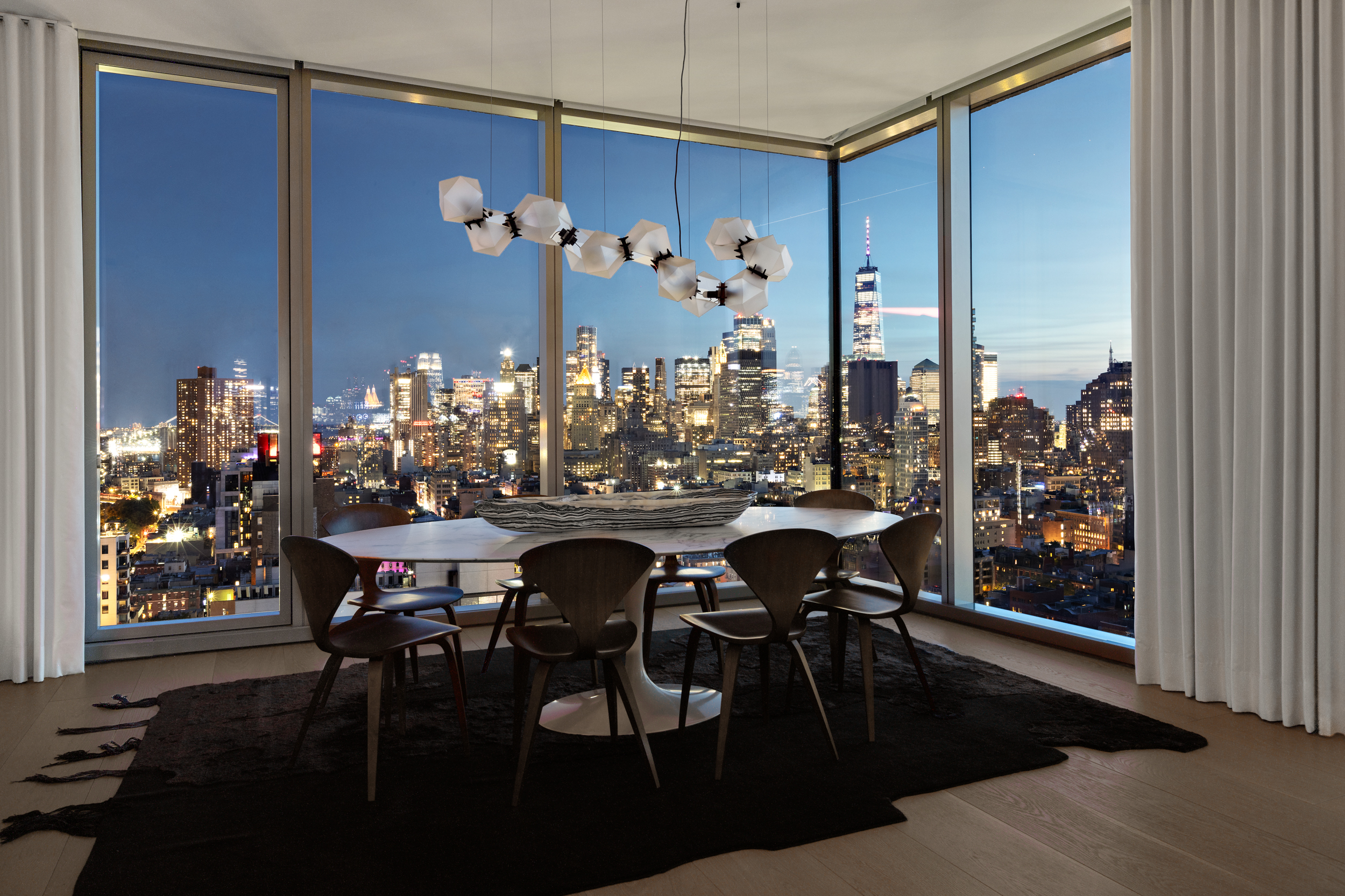 215 Chrystie Street, Unit PH2 Manhattan, NY 10002 - Photo 6 of 30 a view of a dining room with furniture and chandelier