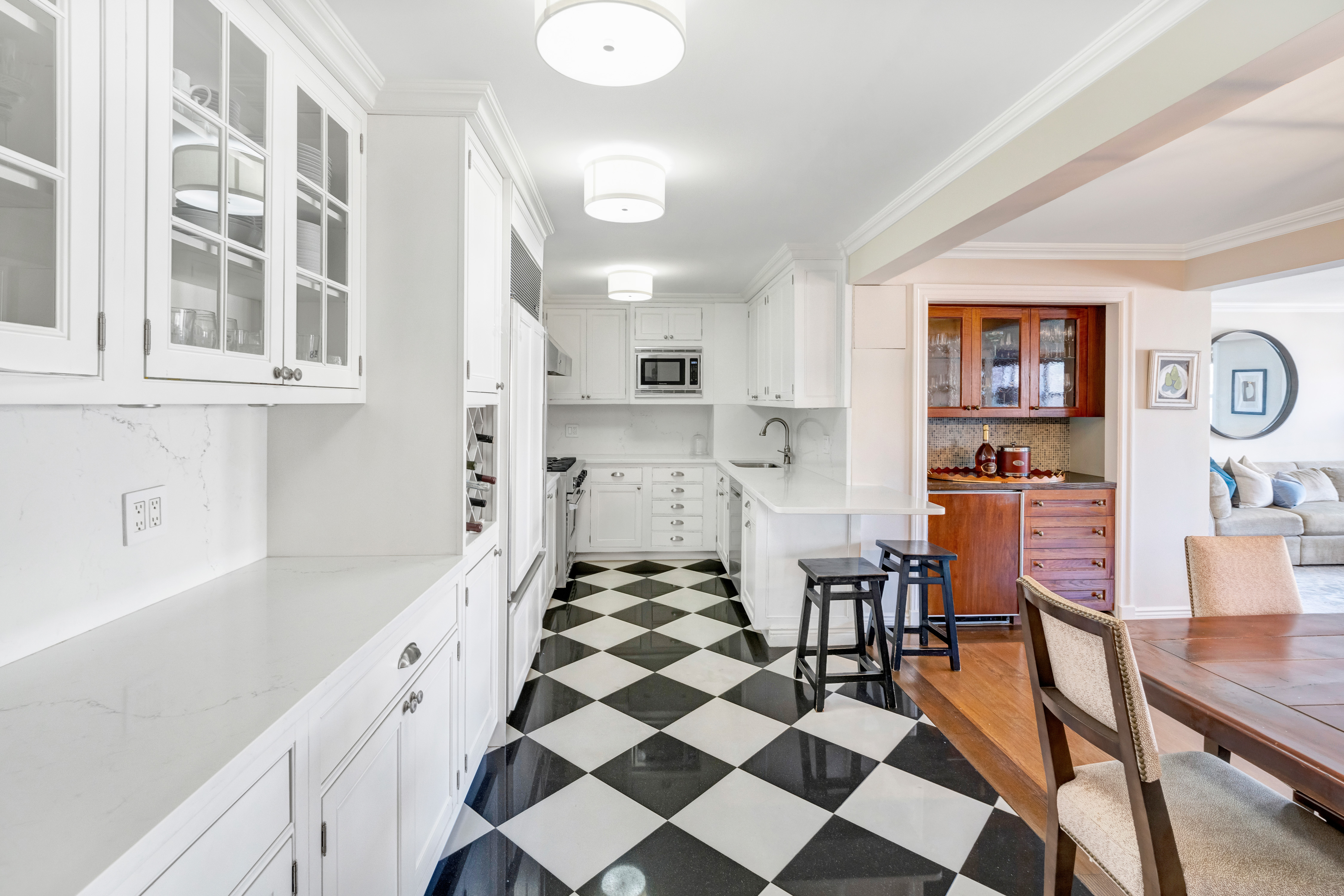 444 East 84th Street, Unit PHE Manhattan, NY 10028 - Photo 4 of 12 a kitchen with stainless steel appliances a refrigerator and cabinets