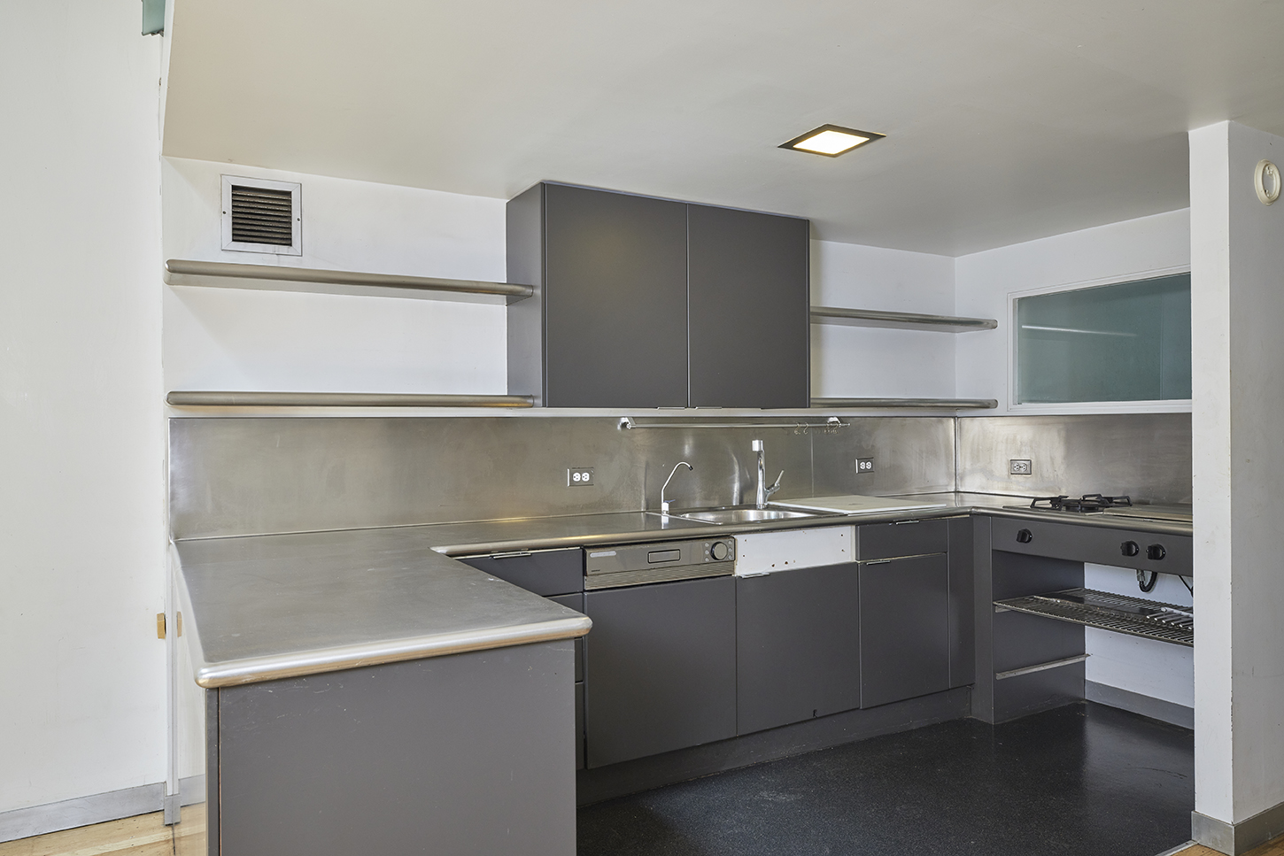 250 Mercer Street, Unit C603 Manhattan, NY 10012 - Photo 5 of 10 a kitchen with a sink a stove and cabinets