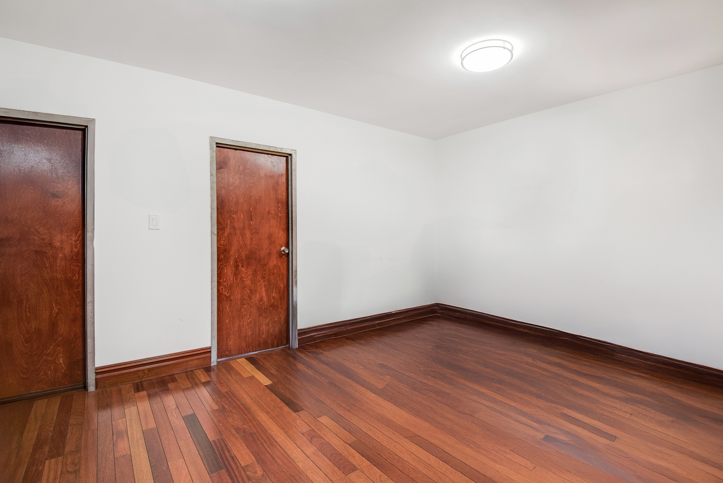 1392 Madison Avenue, Unit 28 Manhattan, NY 10128 - Photo 7 of 10 an empty room with wooden floor and closet