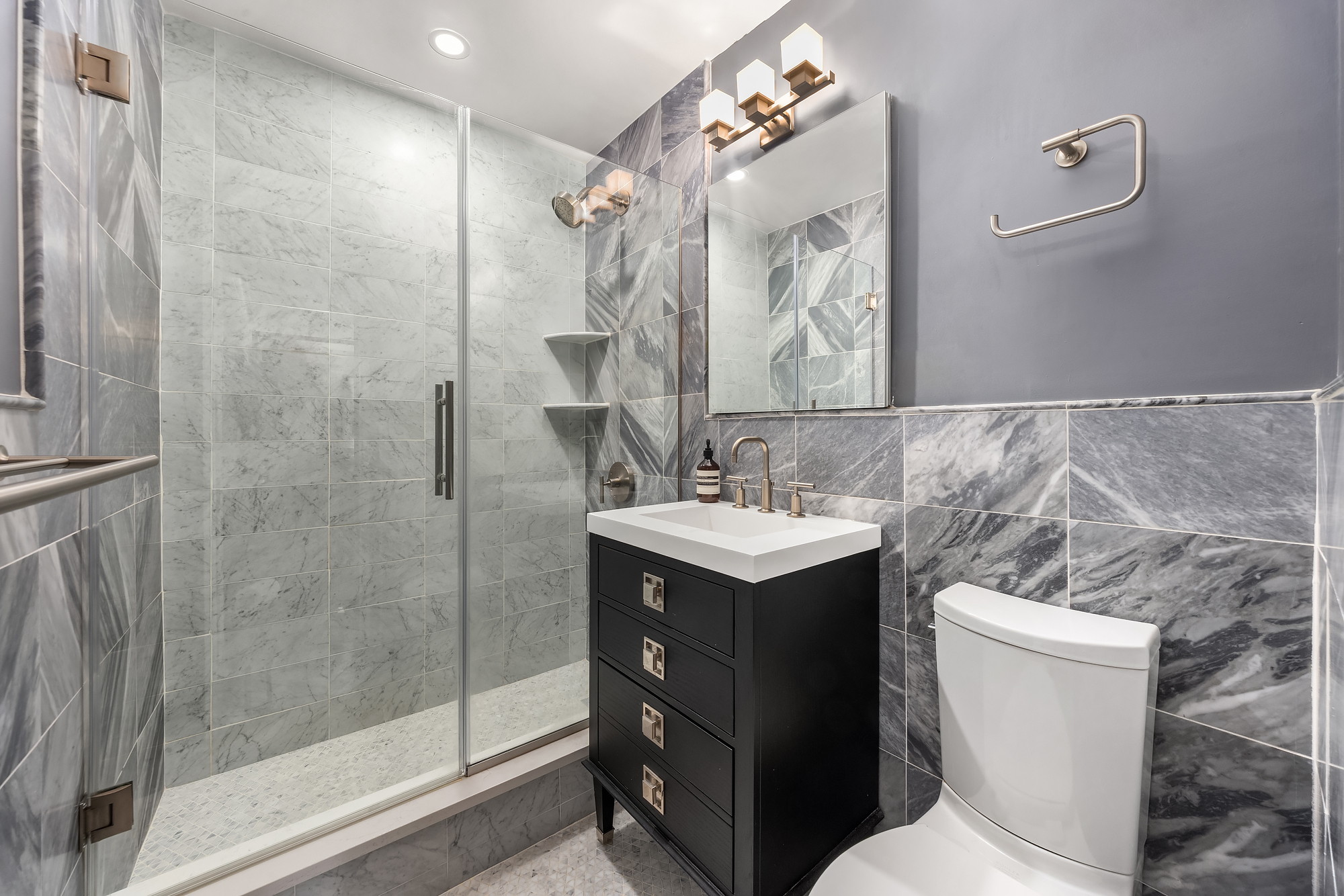 101 West 12th Street, Unit 8N Manhattan, NY 10011 - Photo 11 of 17 a bathroom with a sink vanity mirror and toilet