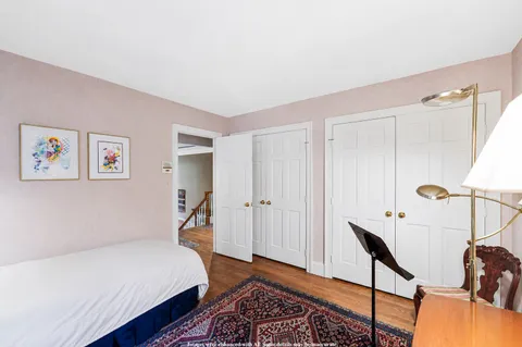 a bedroom with furniture and a book shelf