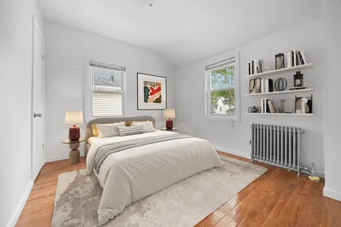 a bedroom with a bed and a book shelf