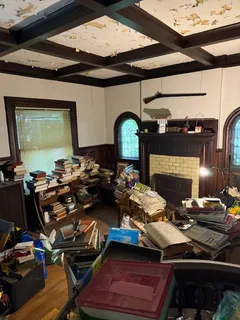 a room with lots of chairs and a chandelier