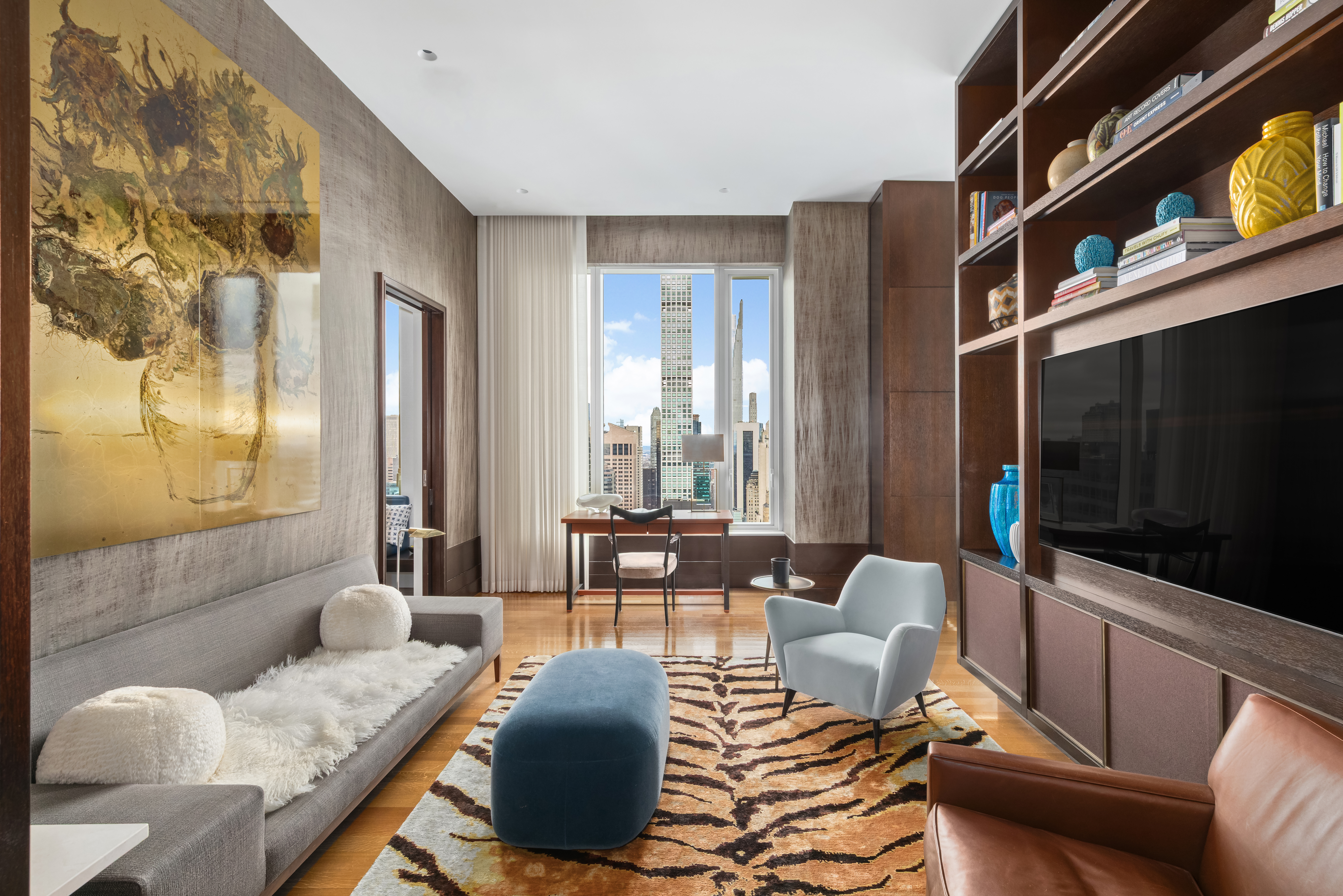 252 East 57th Street, Unit 60A Manhattan, NY 10022 - Photo 15 of 28 a living room with furniture and a flat screen tv