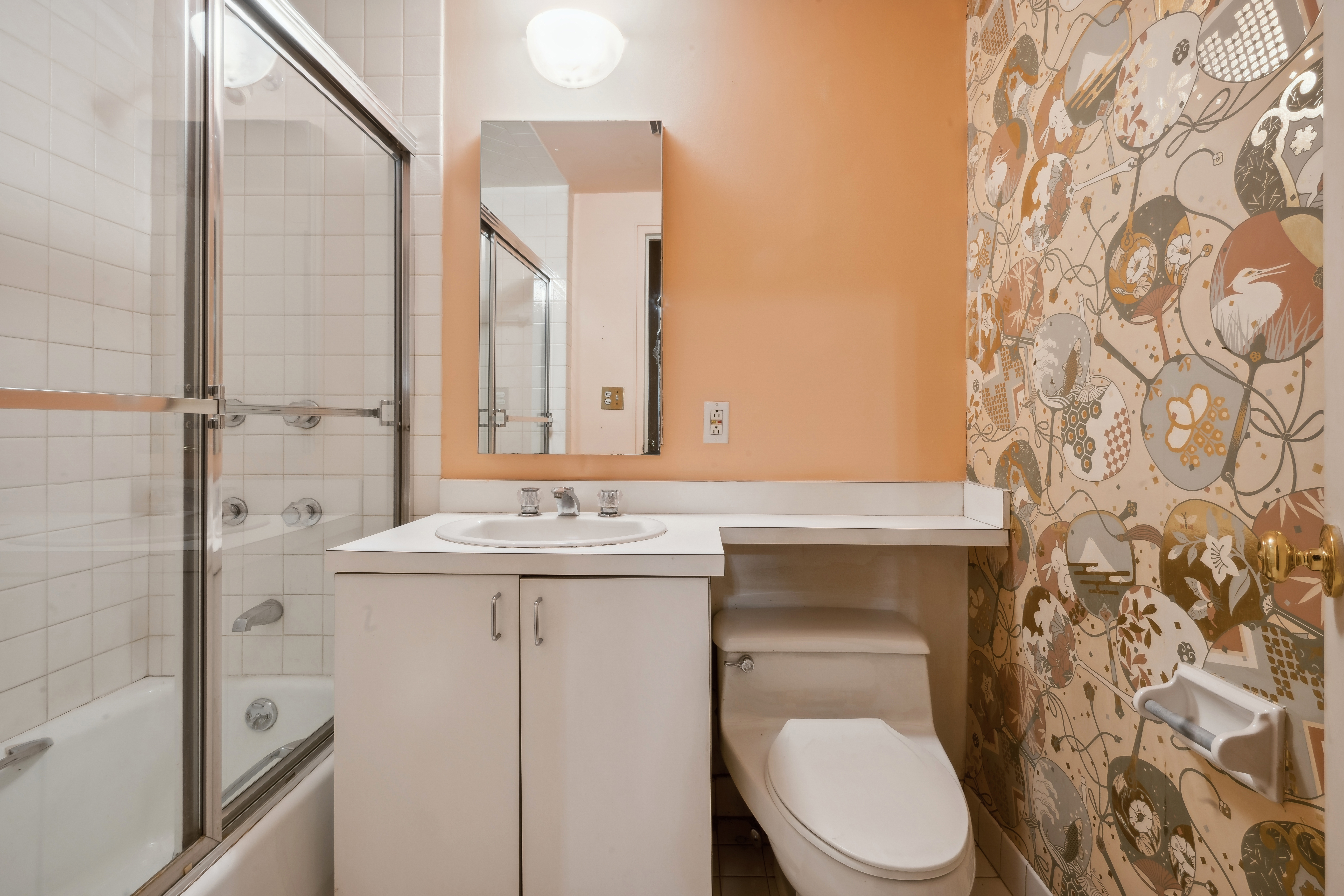 12 Beekman Place, Unit 2F Manhattan, NY 10022 - Photo 4 of 7 a bathroom with a sink a toilet and a mirror