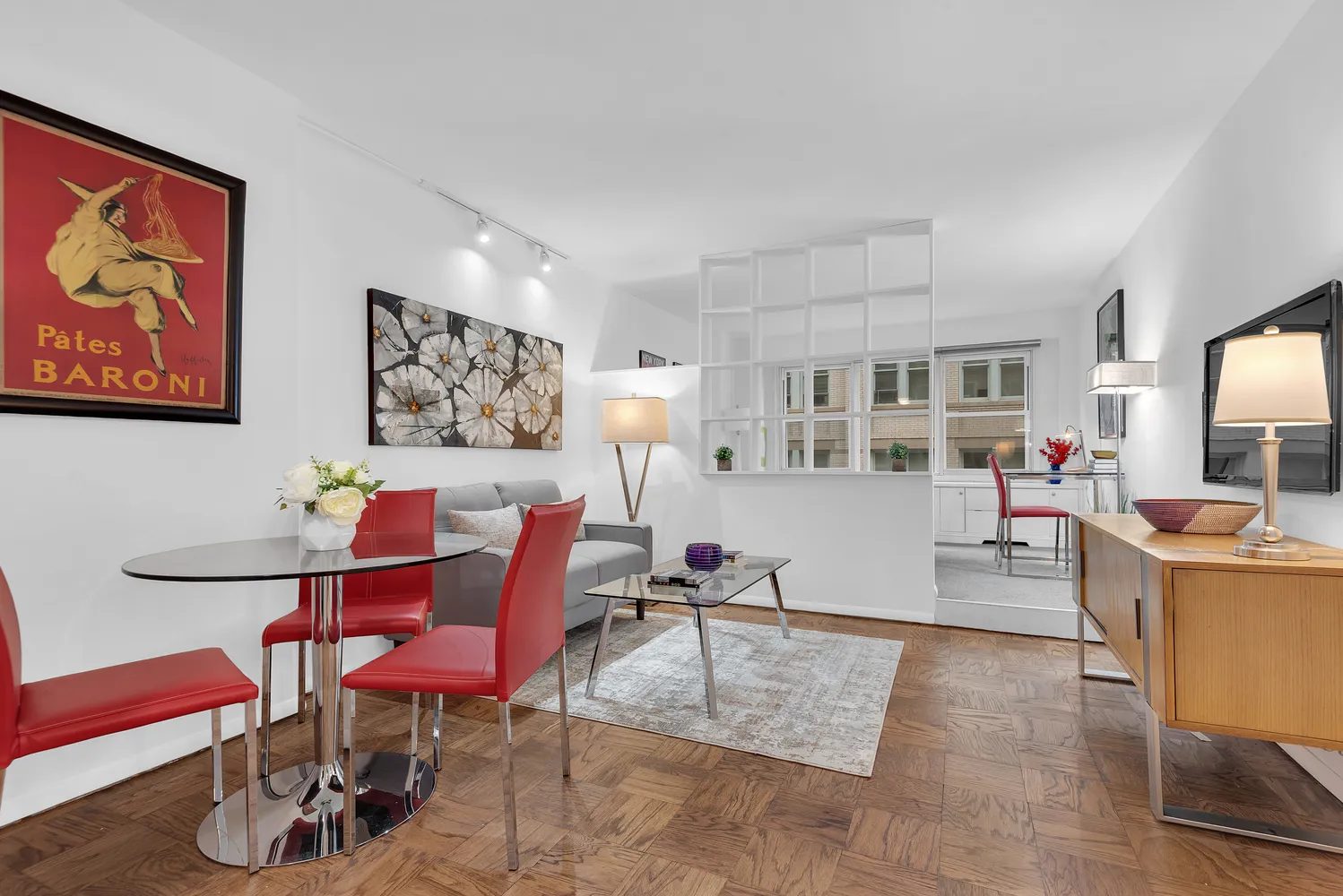 a living room with furniture and a wooden floor