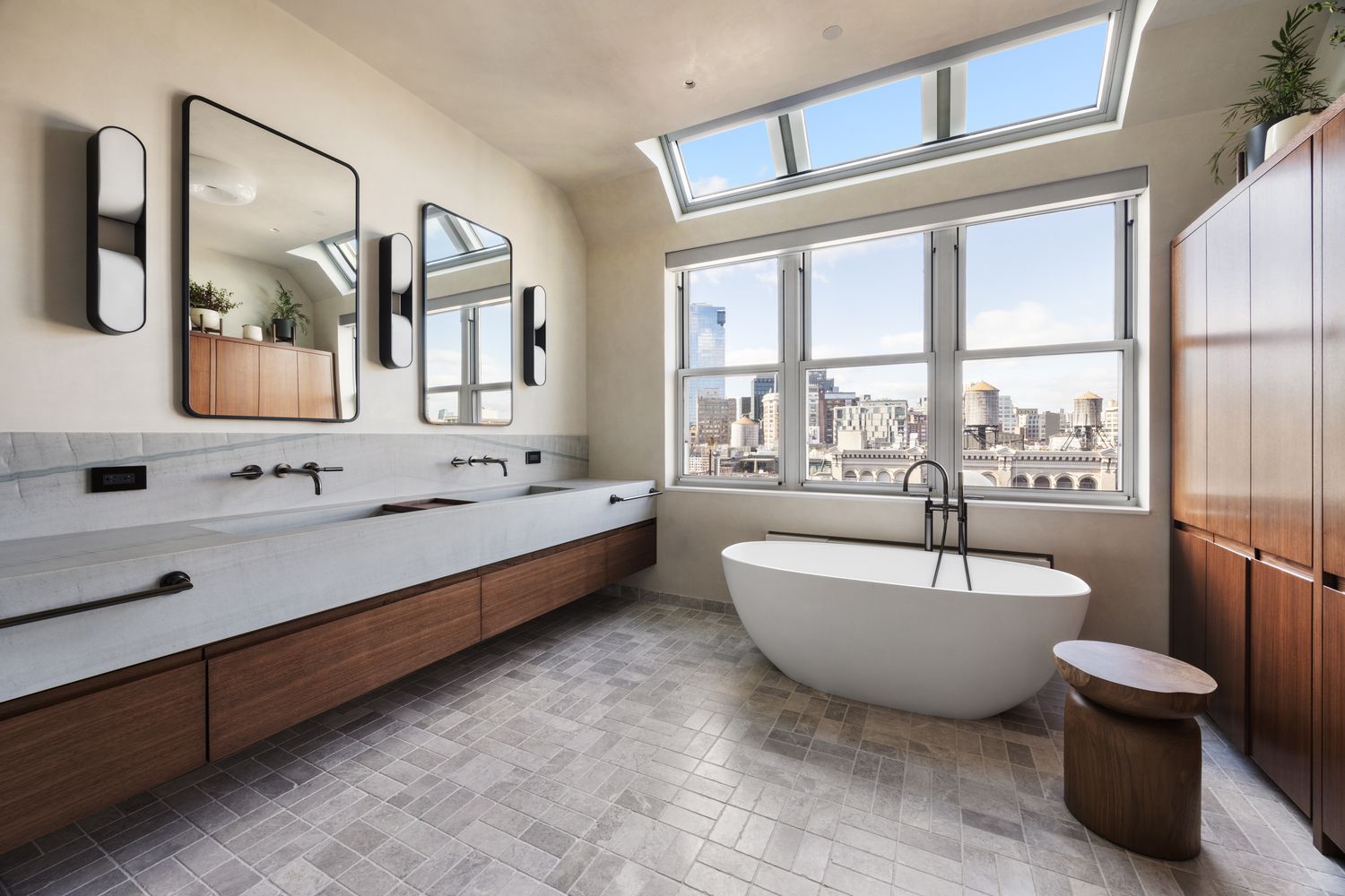 a spacious bathroom with a double vanity sink a mirror and a bathtub