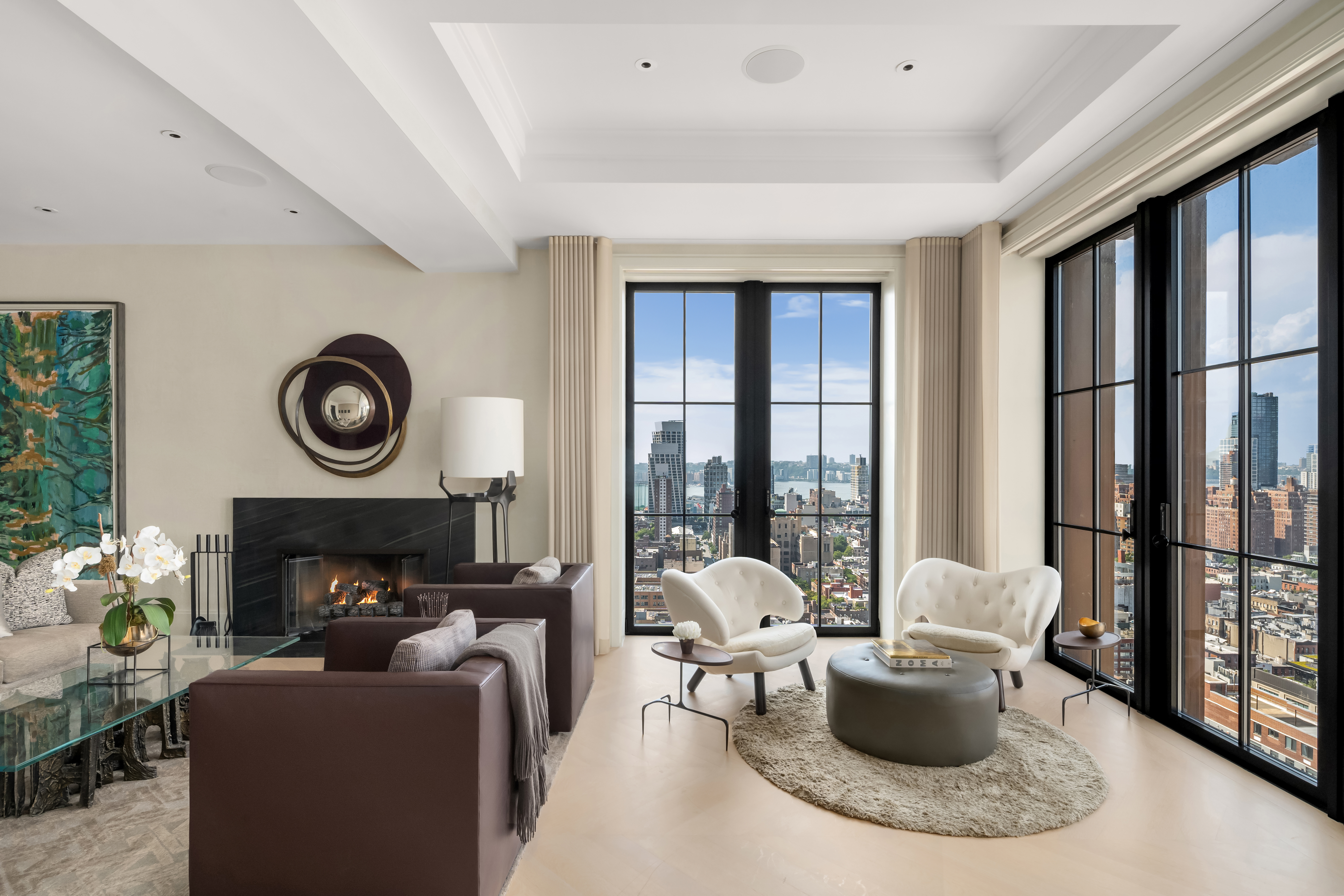 212 West 18th Street, Unit 19C Manhattan, NY 10011 - Photo 2 of 27 a living room with furniture a fireplace and a large window