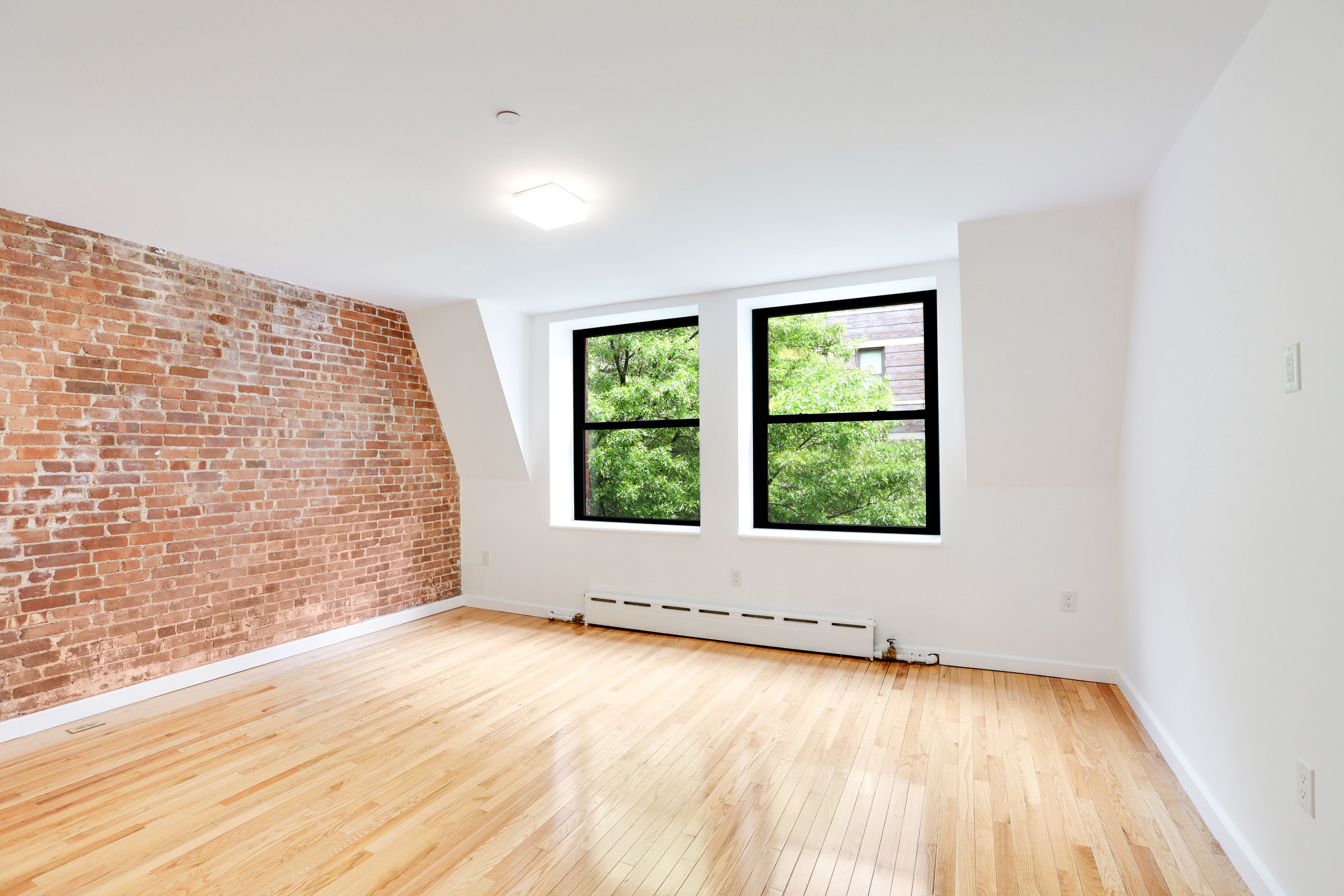 230 West 75th Street, Unit 4 Manhattan, NY 10023 - Photo 3 of 16 an empty room with wooden floor and windows