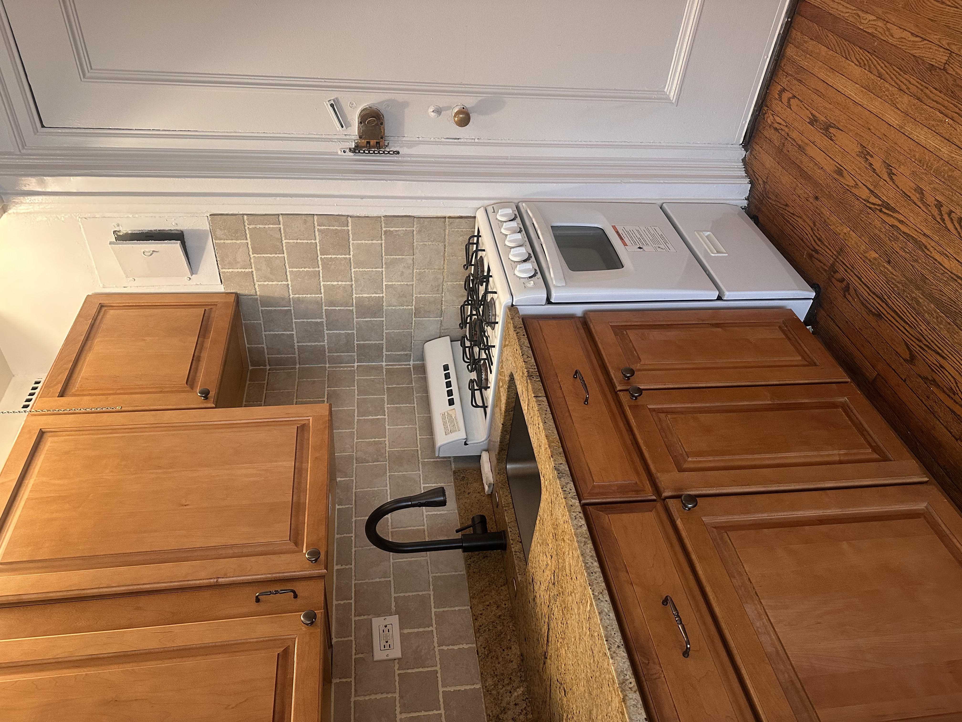 457 West 57th Street, Unit 505 Manhattan, NY 10019 - Photo 2 of 10 a kitchen with stainless steel appliances granite countertop a stove a sink and a microwave