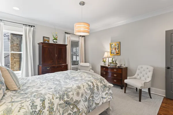 a bedroom with a bed and a dresser in it