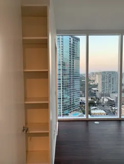 a view of a room with wooden floor and a window