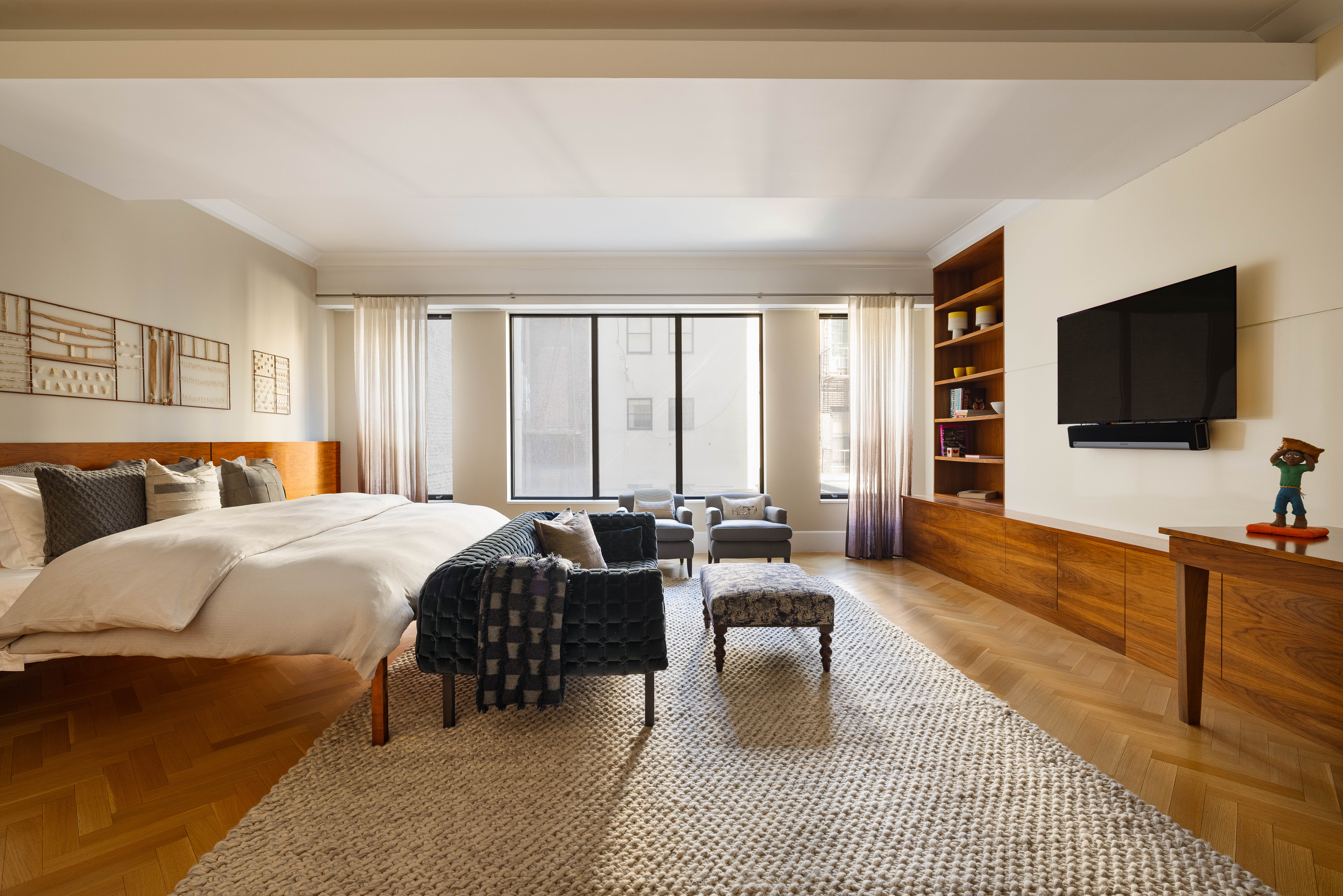 17 East 12th Street, Unit 3 Manhattan, NY 10003 - Photo 17 of 27 a spacious bedroom with a bed and a flat screen television