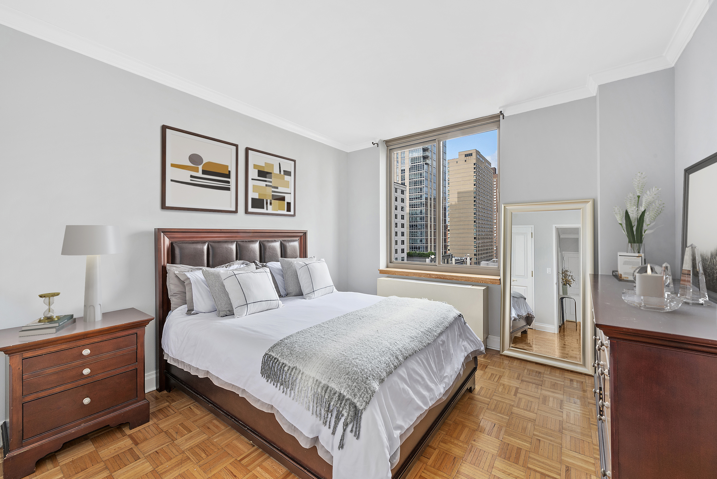 400 East 90th Street, Unit 8E Manhattan, NY 10128 - Photo 4 of 6 a bedroom with a bed and a large window